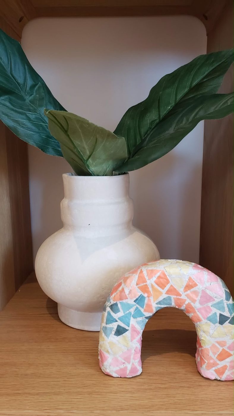 Soft arch-shaped object in a painted patchwork pattern