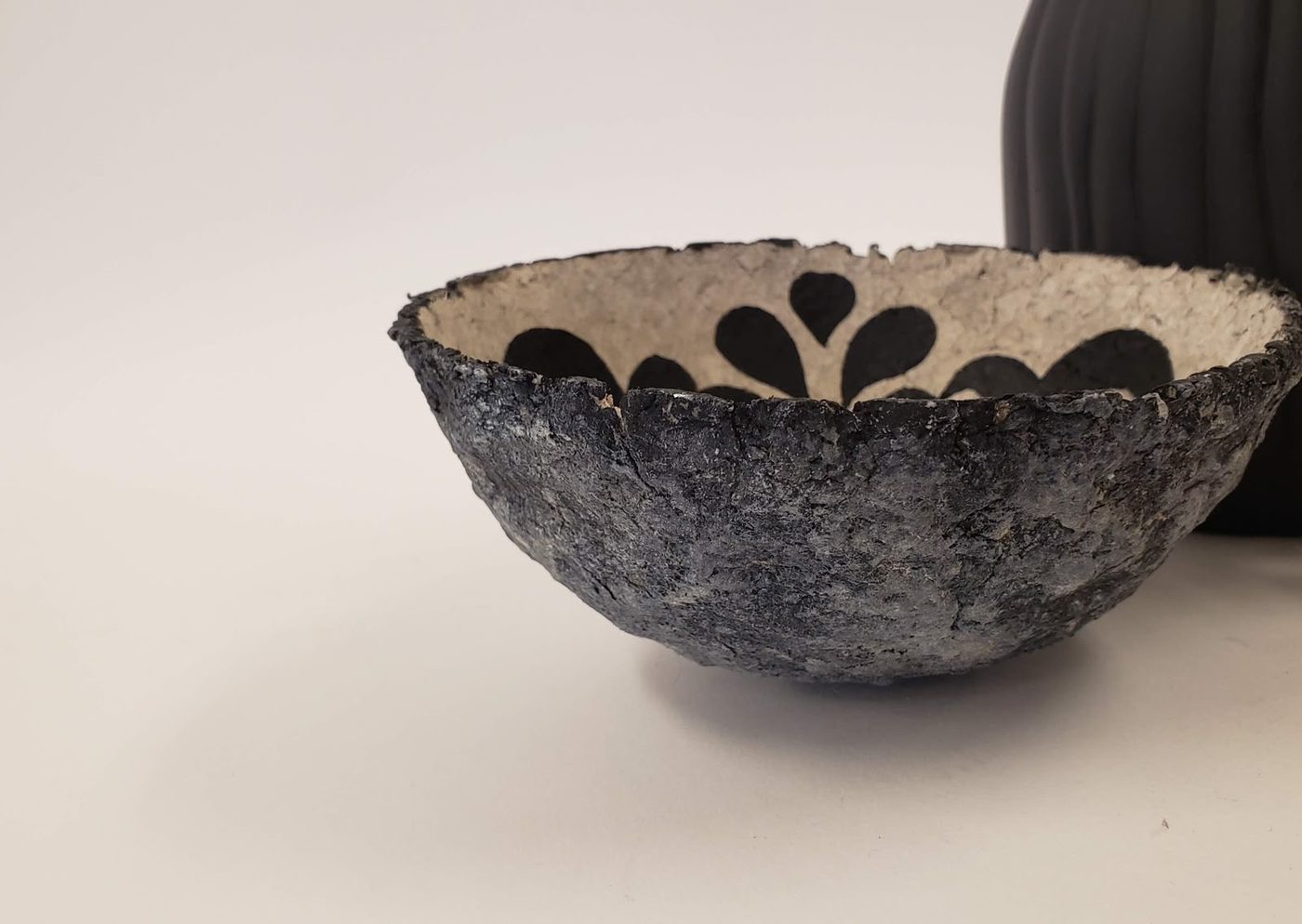 Textured ceramic bowl with a scalloped edge
