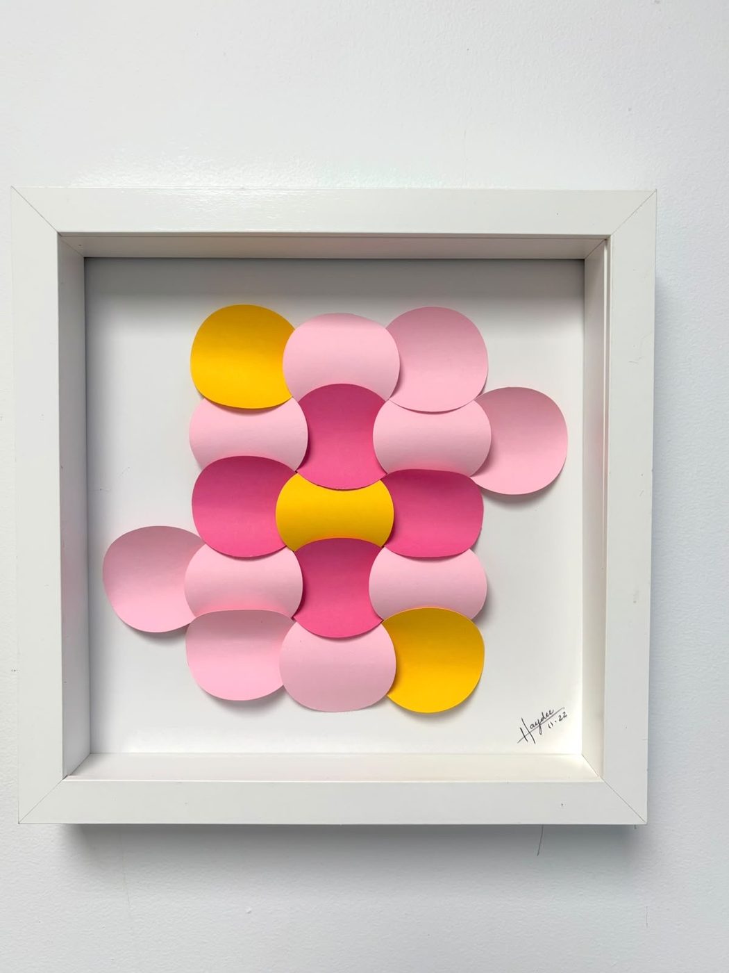 Framed cluster of pink and yellow paper circles