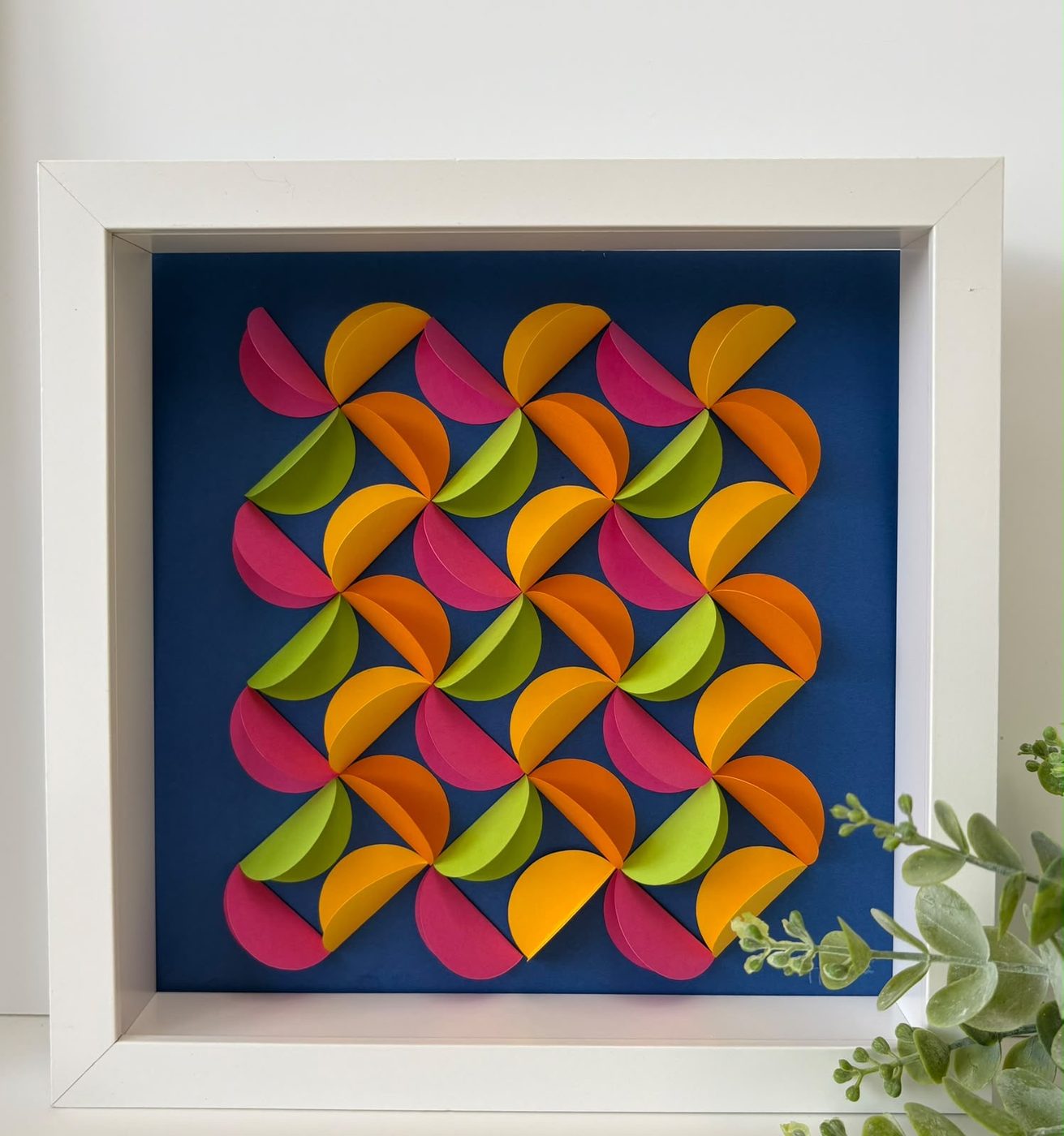 Framed scalloped paper piece in pink, orange, green and navy