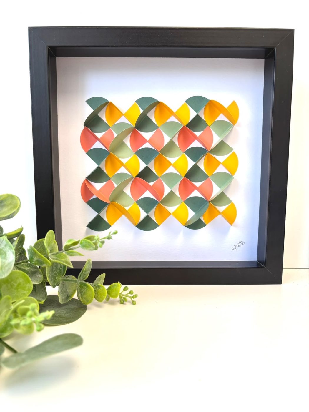Framed scalloped paper piece in teal, coral and yellow