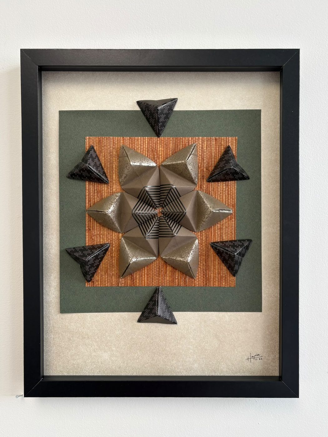 Framed origami star wall piece in metallic and black